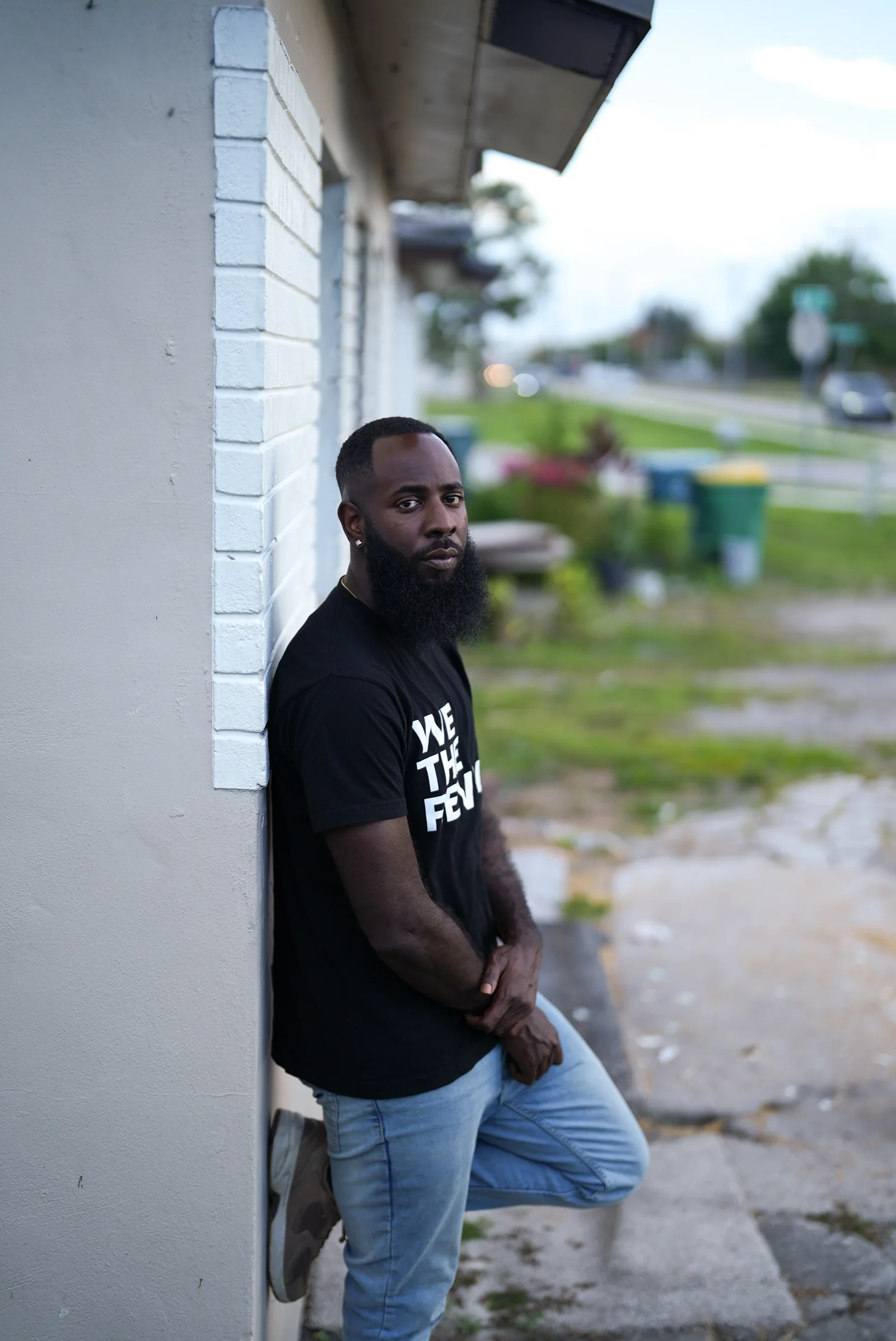 Nijalon Dunn of We The Revolt leans on a doorway in Immokalee, Florida