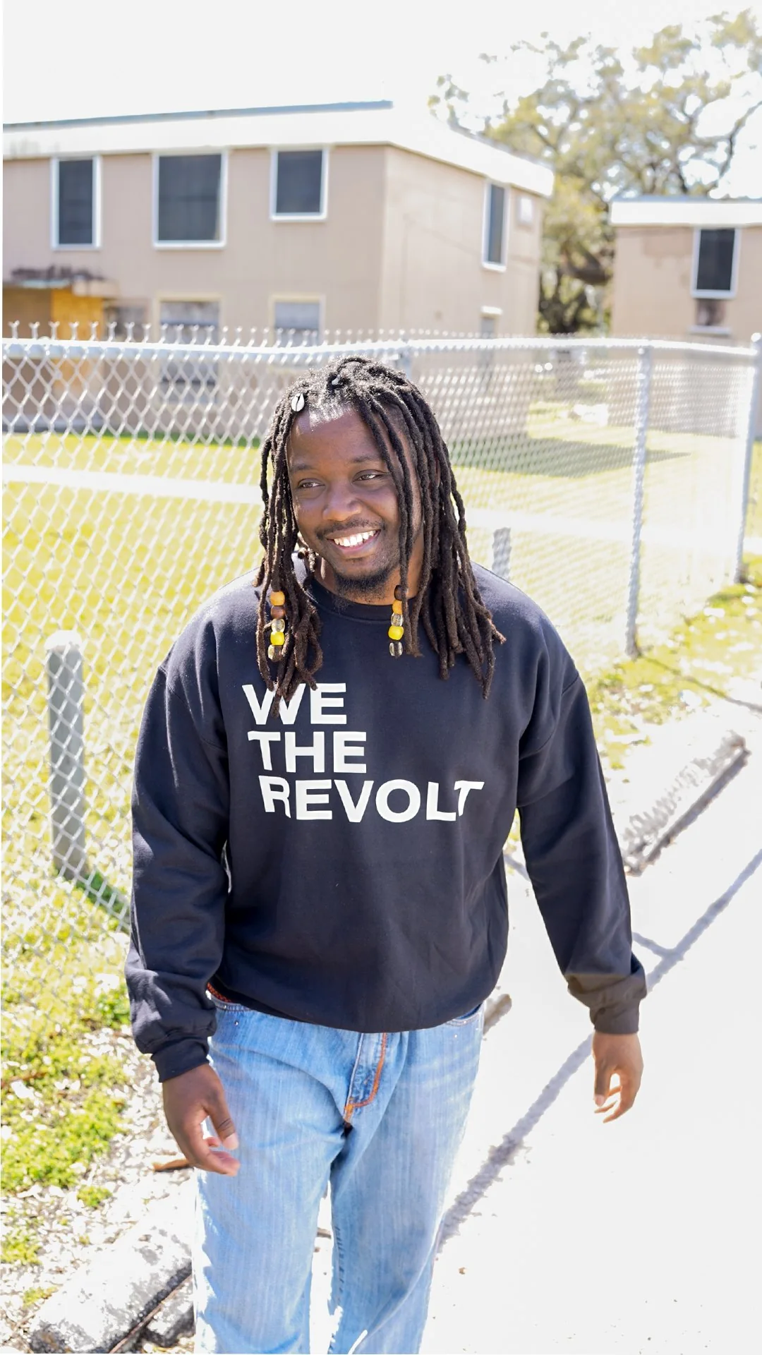 A young man in a We The Revolt sweatshirt walks toward the camera