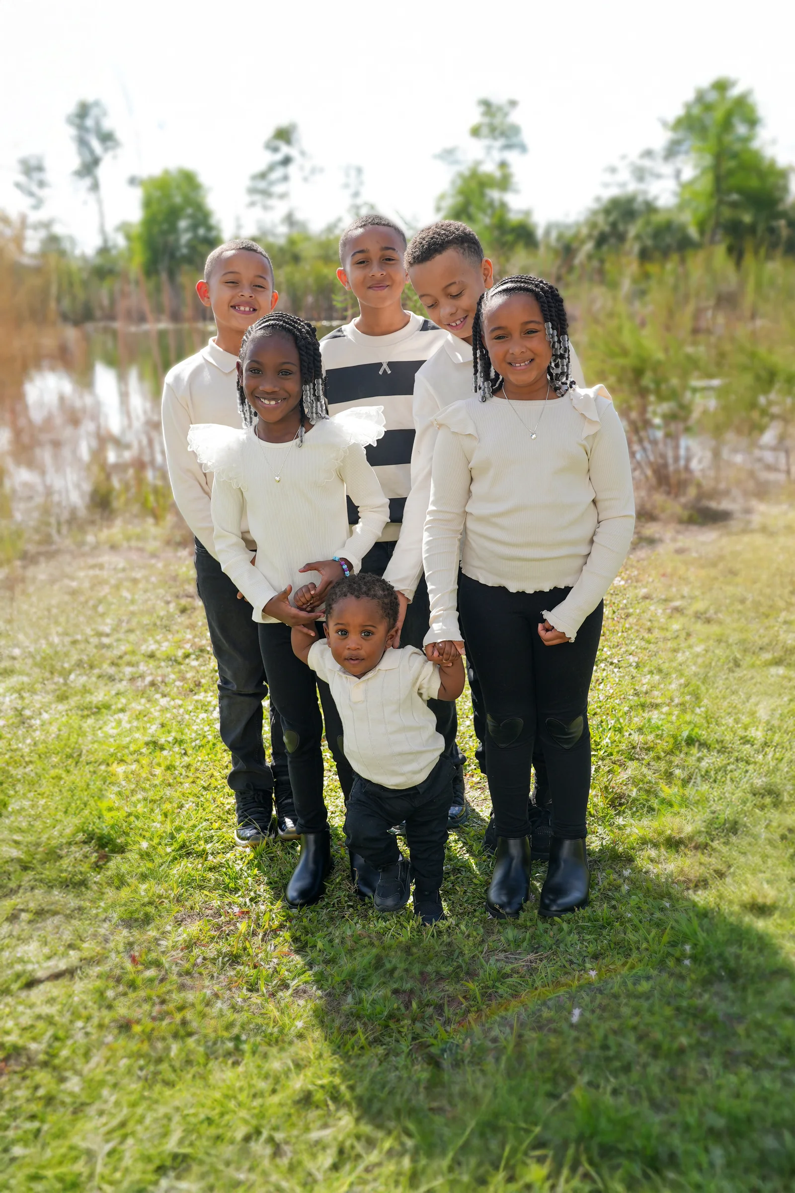 The six Lillard children stand together in a grassy field