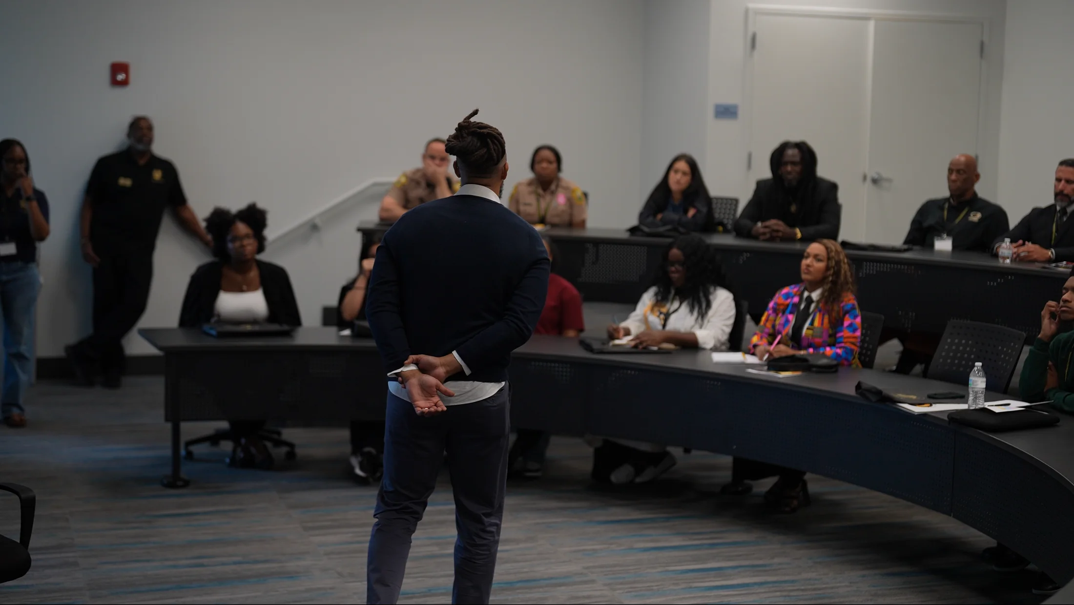 Ronnie Lillard stands before a lecture room of students, officers and community leaders at St. Thomas University