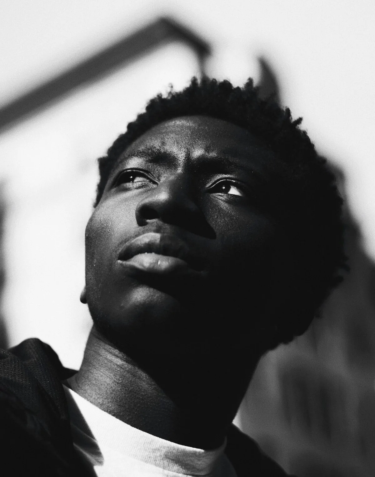 A young man looks up, black and white portrait